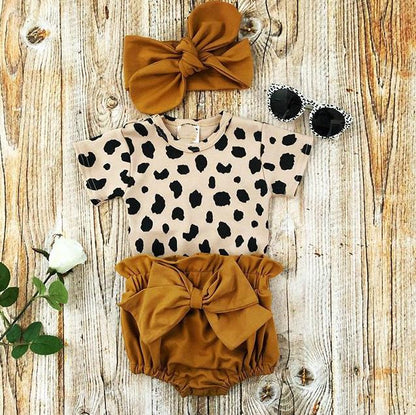 Baby girl romper featuring a full leopard print pattern, perfect for a cute baby gift.