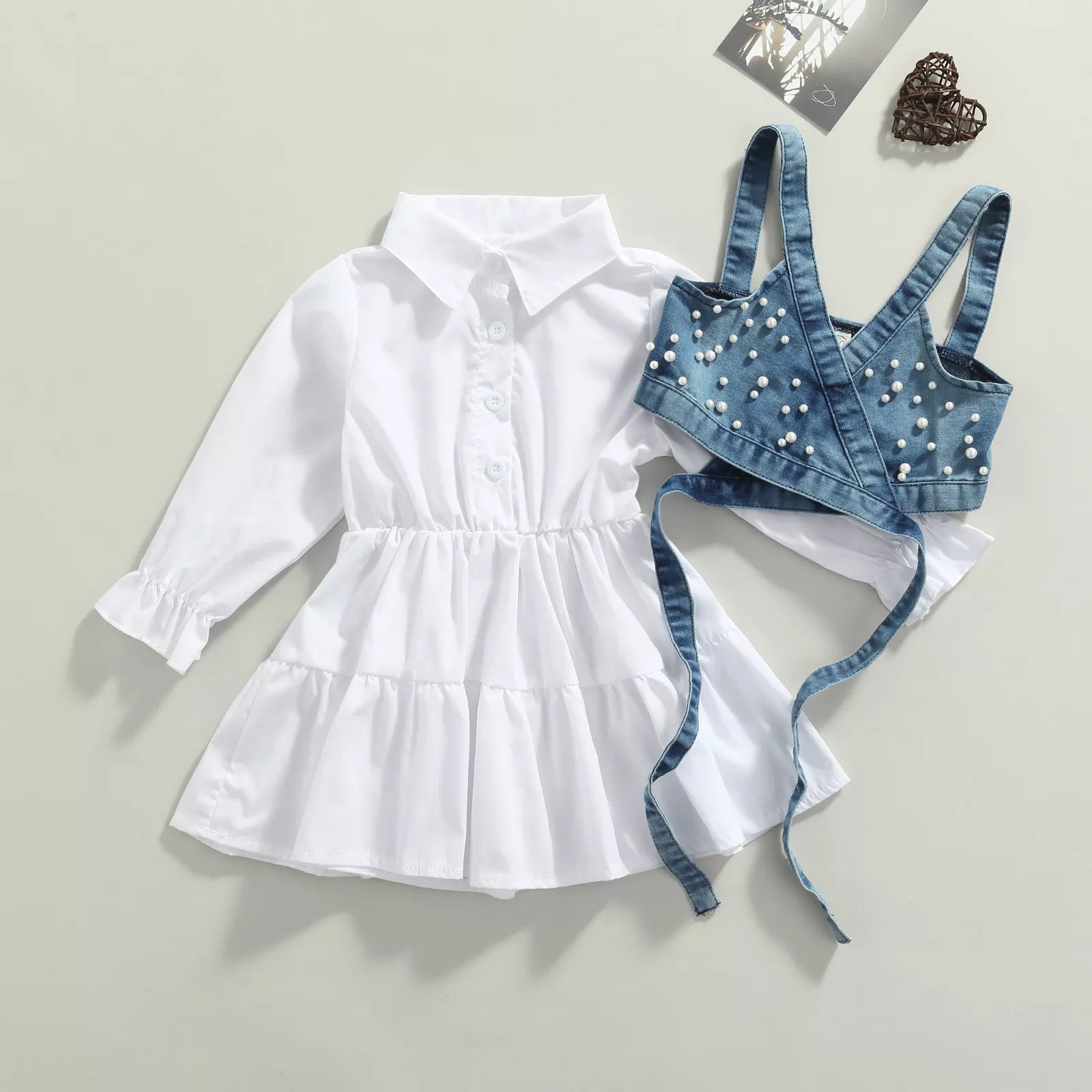 Baby girl in long sleeve shirt dress and beaded denim vest, a cute spring autumn toddler outfit.