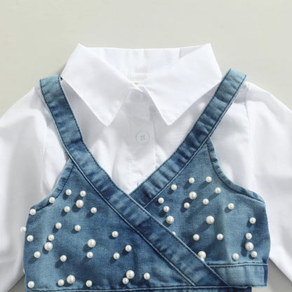 Close-up of beaded denim vest on a baby girl's long sleeve dress outfit, stylish kids fashion.