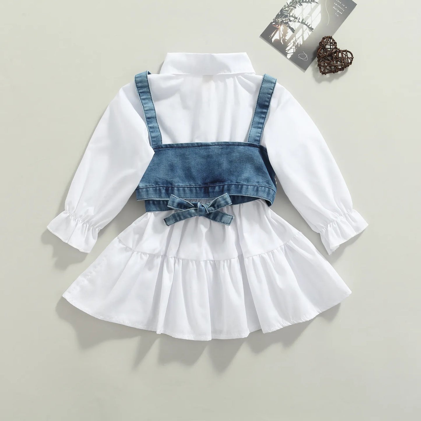 Complete baby girl set featuring a comfortable long sleeve dress and fashionable denim vest.