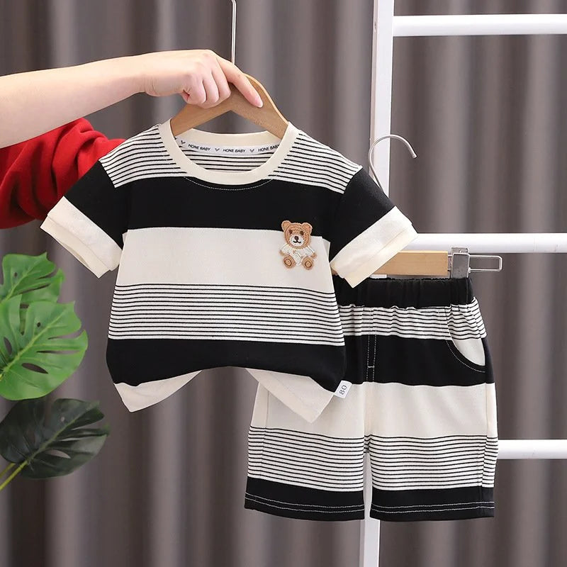 Close-up of baby girls' striped summer tracksuit top and shorts, soft cotton play wear