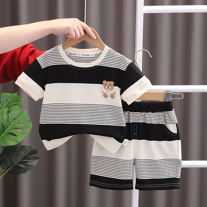 Close-up of baby girls' striped summer tracksuit top and shorts, soft cotton play wear
