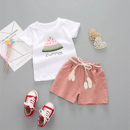 Close-up of cartoon print on girls' pink cotton summer top, part of a stylish kids outfit