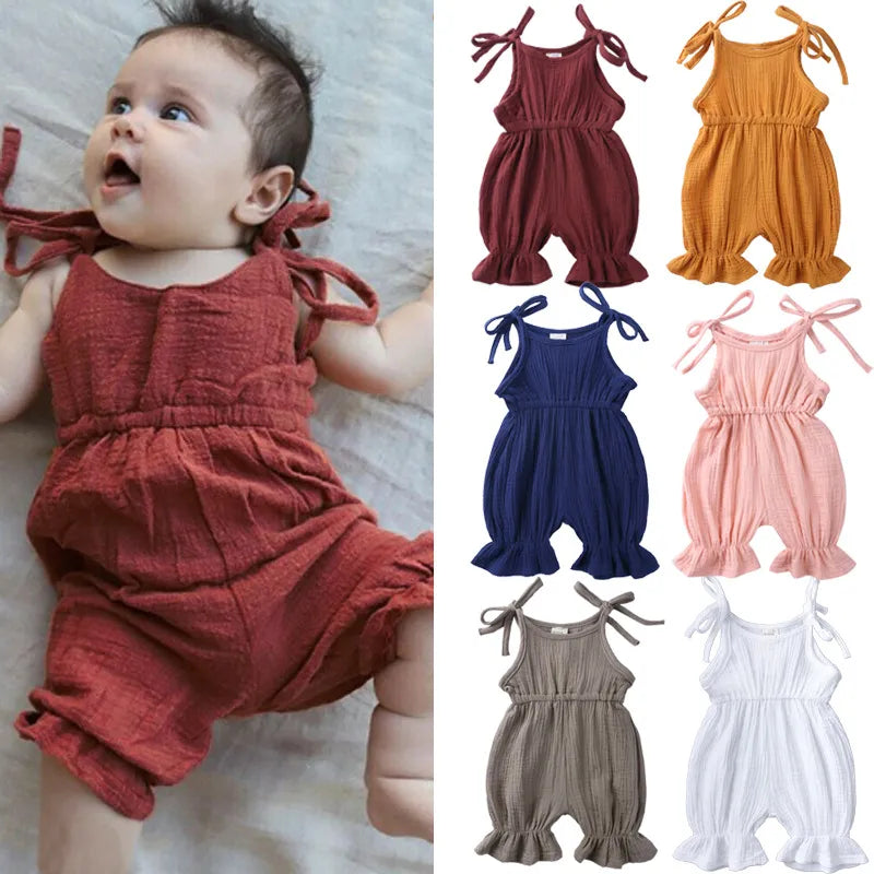 Baby girl in pink cotton sleeveless romper jumpsuit, comfortable toddler summer outfit.