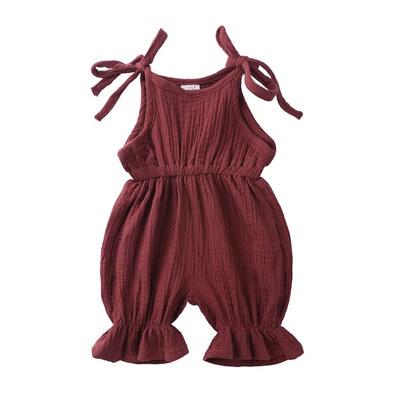 Front view of a baby girl's patterned cotton sleeveless romper, toddler clothing.