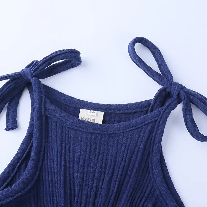 Baby girl in a stylish sleeveless romper, cotton jumpsuit comfortable for all-day wear.