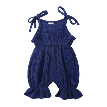 Toddler girl exploring in a breathable cotton sleeveless romper, ideal summer playwear.