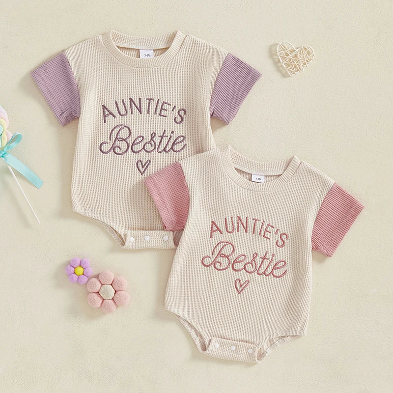 Baby girl in pink waffle knit summer romper with embroidery, short sleeve jumpsuit for infants.
