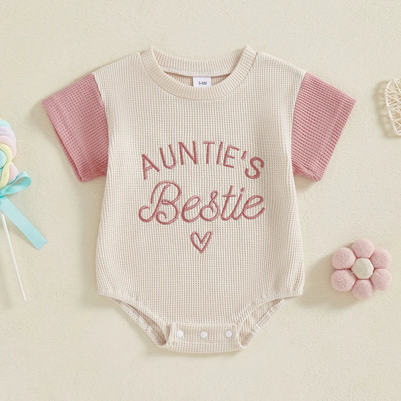 Newborn girl wearing purple waffle knit summer romper, embroidered short sleeve jumpsuit, casual wear.