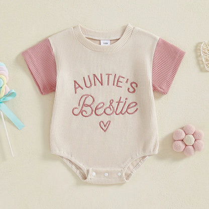 Newborn girl wearing purple waffle knit summer romper, embroidered short sleeve jumpsuit, casual wear.