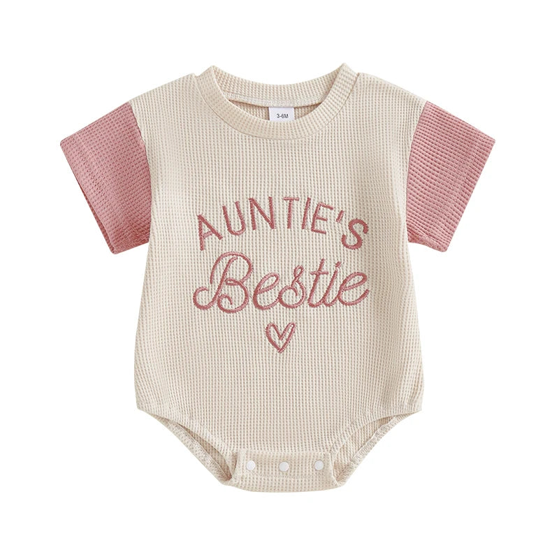 Toddler girl's pink waffle knit romper with delicate embroidery, short sleeve jumpsuit for warm weather.
