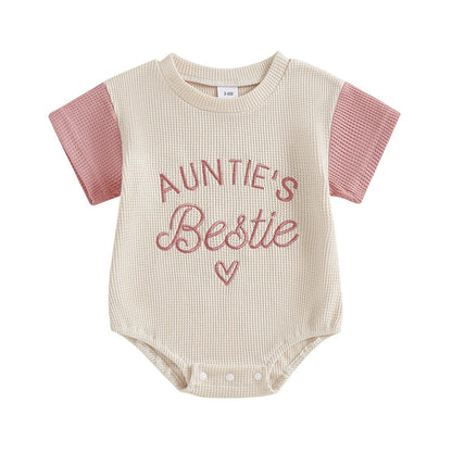 Toddler girl's pink waffle knit romper with delicate embroidery, short sleeve jumpsuit for warm weather.