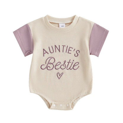 Assorted pink and purple waffle knit baby rompers with embroidery, short sleeve jumpsuits for summer wear.