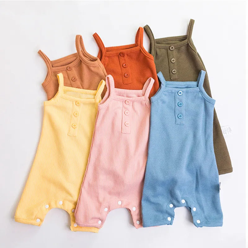Close-up of square collar on baby girl's sleeveless cotton romper, soft fabric, summer baby wear