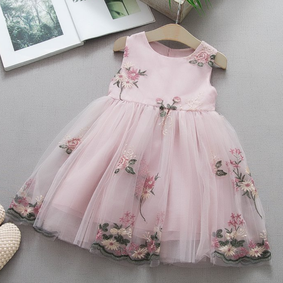 Stylish baby girl in a comfortable, sleeveless floral embroidered princess dress for spring.