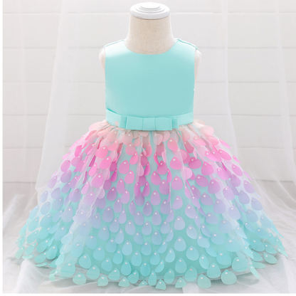 Close-up of shimmery blue and pink mermaid baby dress with layered petal skirt, ideal for a toddler party