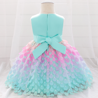 Adorable baby girl wearing a sleeveless mermaid princess dress, blue top, pink petal skirt, baby clothing fashion