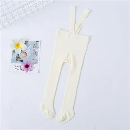Creamy beige knit tights with shoulder straps, an essential for any baby girl's cozy clothing.
