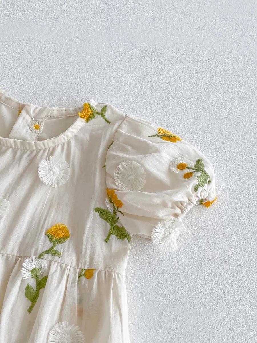 Infant apparel: adorable baby girl short sleeve romper with intricate floral embroidery.