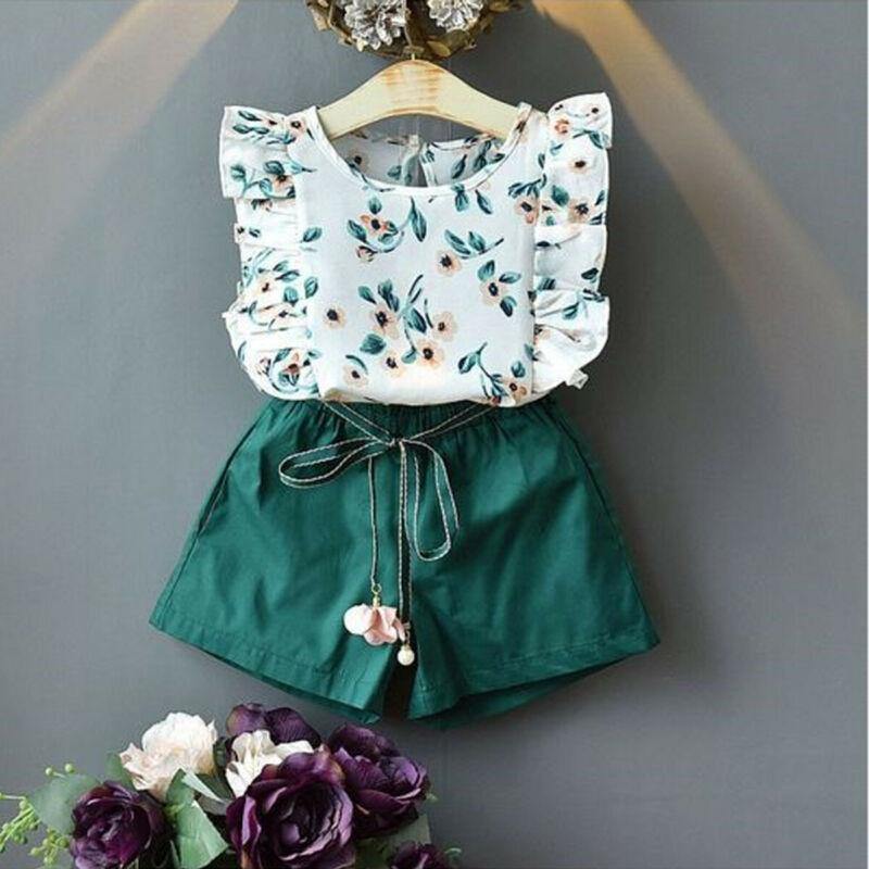 Baby girl in white floral frilly top and green shorts, a cute cotton blend summer outfit set