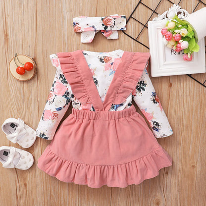 Versatile baby girl outfit: long-sleeve floral romper & brown suspender skirt, great for layering.