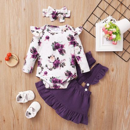 Floral print long-sleeve baby romper with ruffled details & brown suspender skirt for infants.