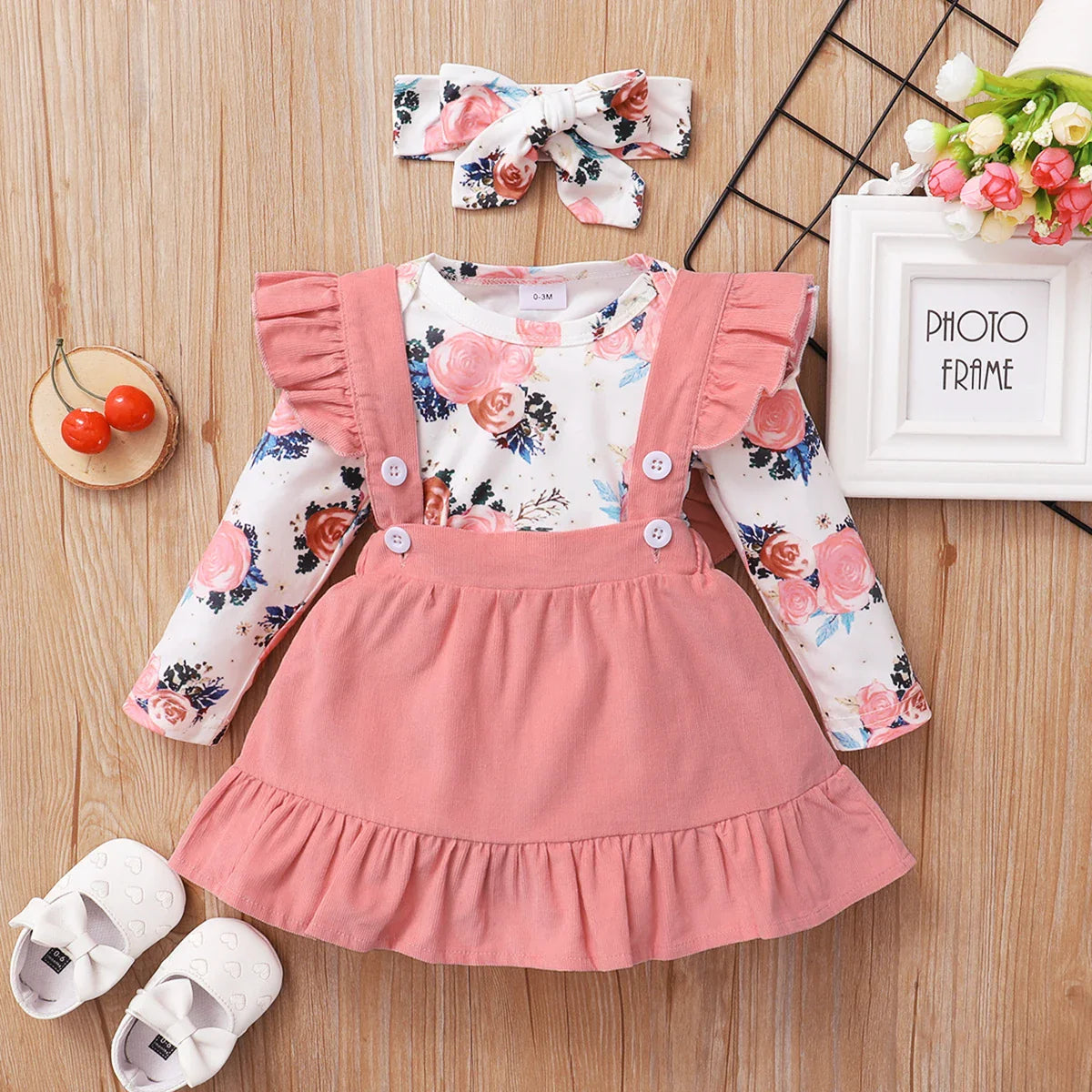 Cute baby girl's floral romper and brown corduroy suspender skirt set, perfect for spring/autumn.