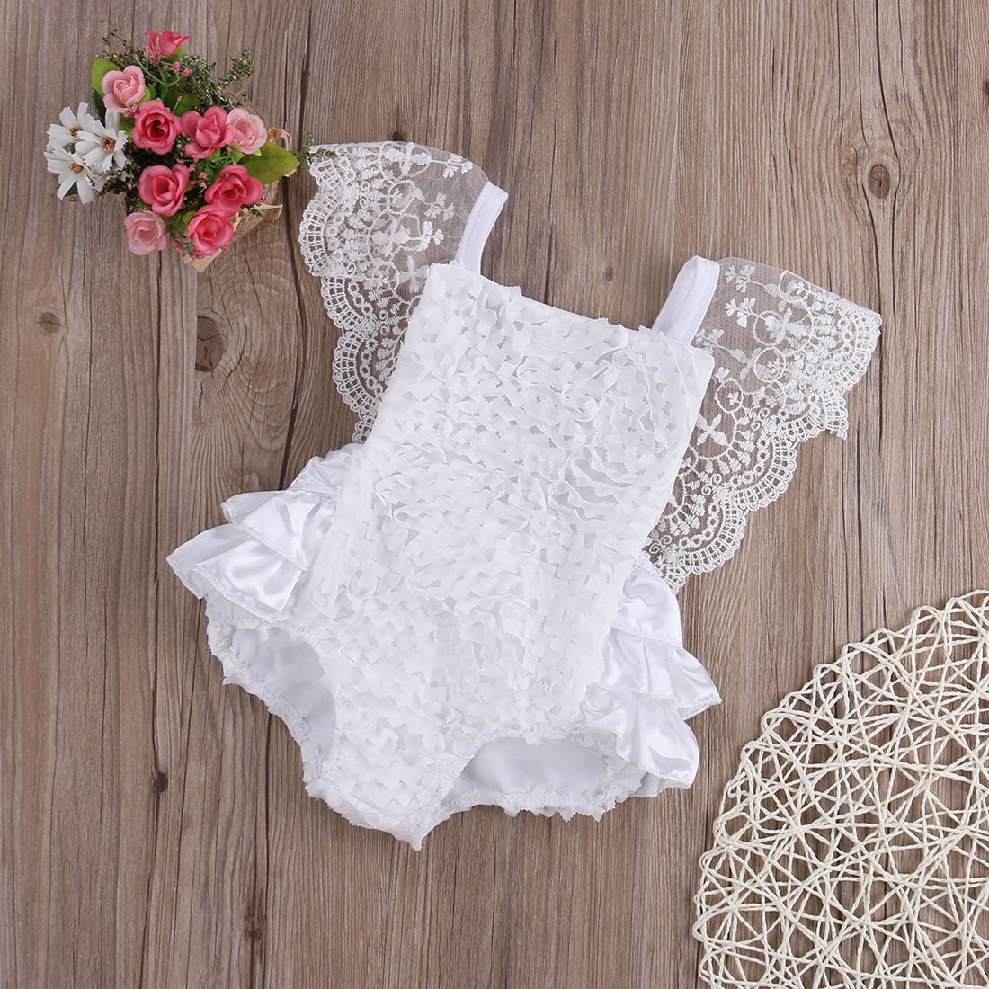 Baby girl in white lace princess bodysuit dress, perfect for newborn outfit or party, made of cotton.