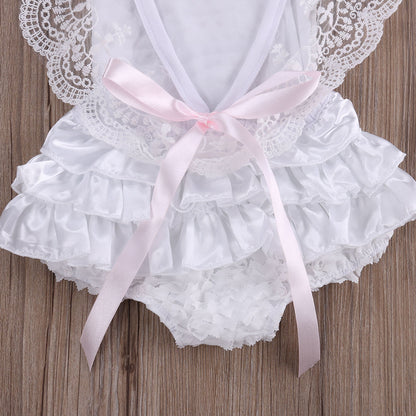 Back view of a baby girl's white lace bodysuit dress, showcasing intricate lace detail and comfortable cotton.