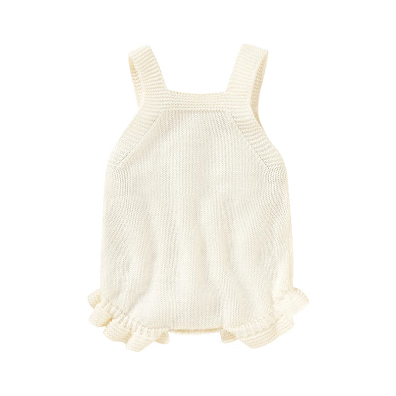 Close-up of pink knitted baby romper with delicate square collar detail