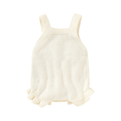 Close-up of pink knitted baby romper with delicate square collar detail