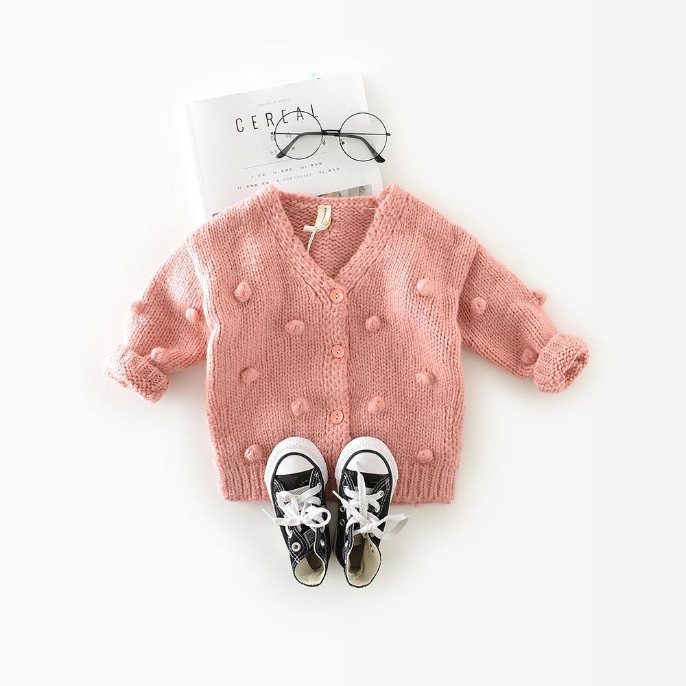 Close-up of baby girl sweater texture, soft wool blend knitwear detail