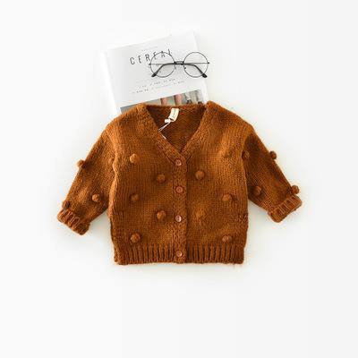Cute baby girl in cozy pink knitted sweater, perfect for cold weather