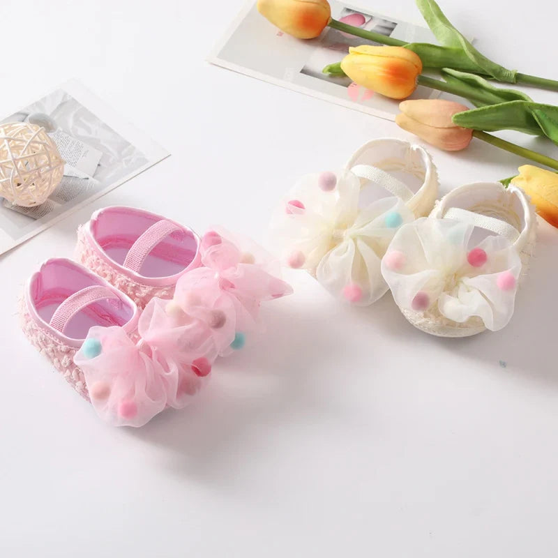 Pair of infant pink soft sole shoes, ideal for baby girl's first steps in spring/autumn