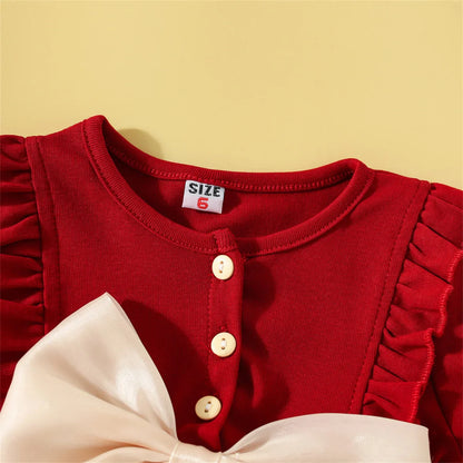 Close-up of the delicate mesh fabric on a baby girl's summer cotton dress with bow