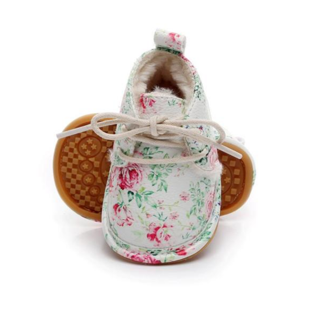 Cute pink fleece baby boots for winter, ensuring warmth for infant girls' feet