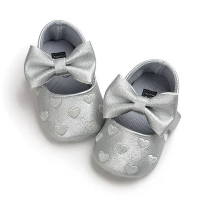 Baby girl moccasins with sweet heart design and elegant bow, perfect soft crib shoes