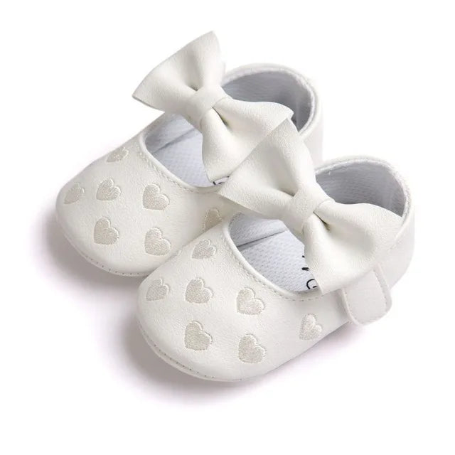 Baby girl moccasins with a lovable heart theme, soft sole and slip-on convenience