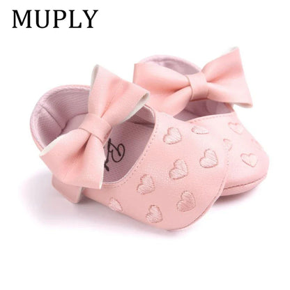Adorable baby girl moccasins with heart pattern and bow detail, soft crib shoes for infants