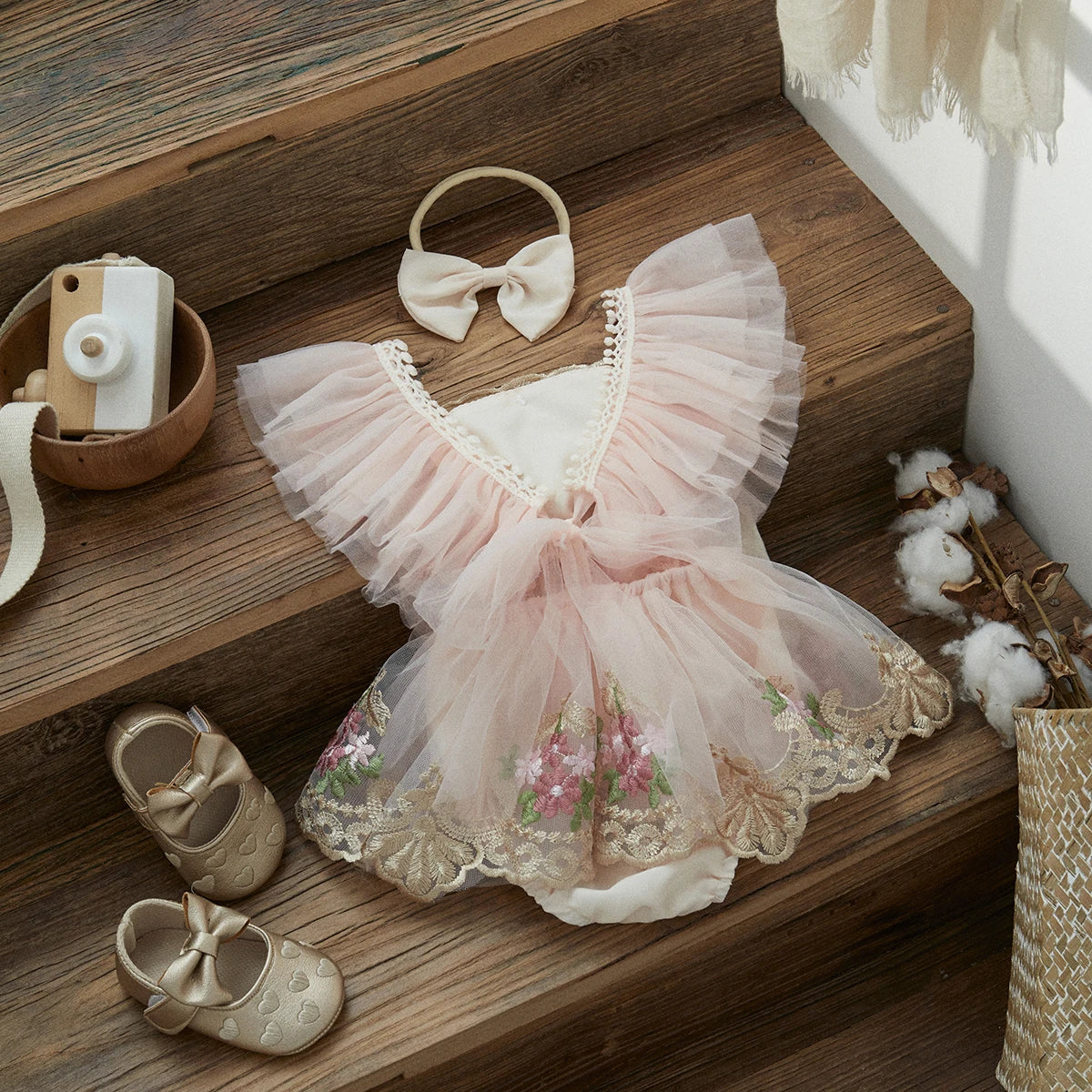 Infant girl's elegant tulle princess romper with headband, perfect for first birthday or special event.