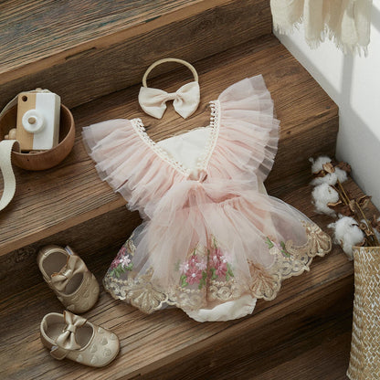 Infant girl's elegant tulle princess romper with headband, perfect for first birthday or special event.
