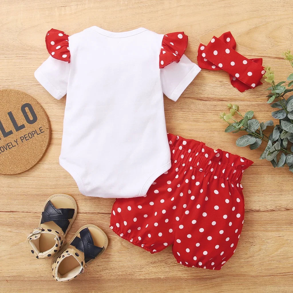 Flat lay of a baby girl's red polka dot summer bodysuit set on a white background