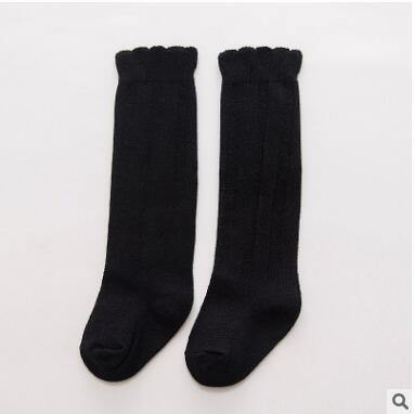 Soft and warm ribbed knee-high baby socks in a pastel green shade for girls.