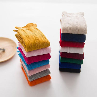 Pack of ribbed knee-high socks for baby girls, featuring various cute designs.