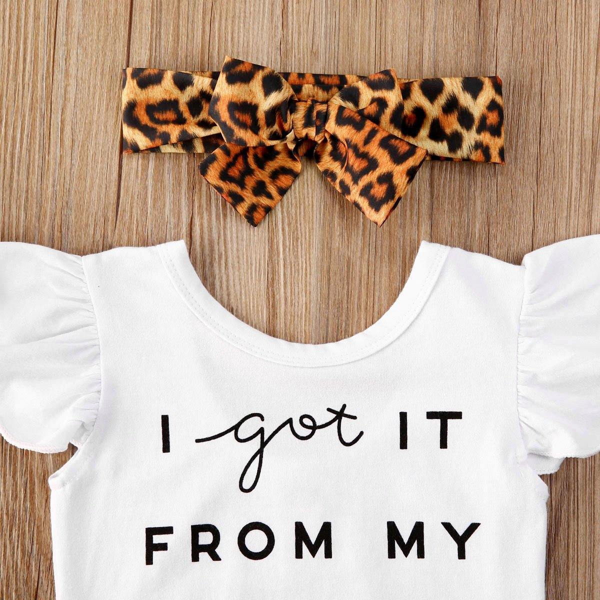 Close-up of infant girl romper featuring 'I Got It From My Mama' script and brown leopard print ruffle skirt