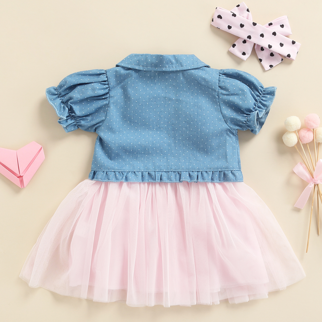 Toddler girl in a stylish 3-piece summer outfit: polka dot tulle dress, denim jacket, matching headband