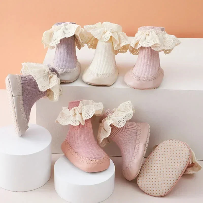 Baby girl's anti-slip ruffle bow sock shoes, soft sole first walker infant footwear in pink.