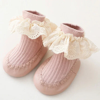 Soft sole baby girl sock shoes with anti-slip grip, perfect for new walkers.