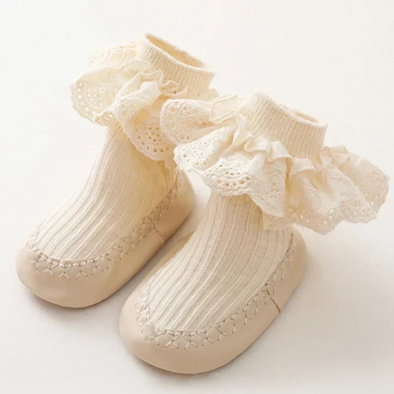 Baby girl's stylish anti-slip sock shoes with a cute ruffle and bow detail for everyday wear.