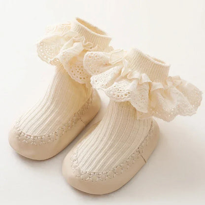 Baby girl's stylish anti-slip sock shoes with a cute ruffle and bow detail for everyday wear.